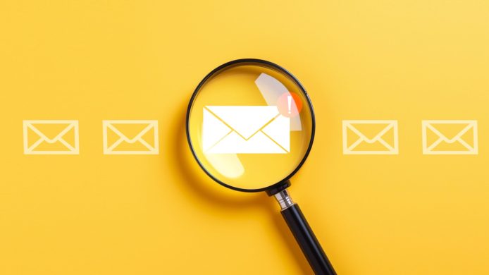 Email alert warning and notification alarm concept, Magnifying glass focus on notification email, spam mail and email detection.