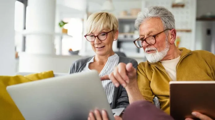 A couple sitting in front of their computers having a discussion