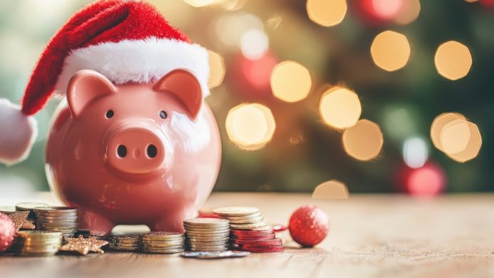 Festive piggy bank with santa hat and gift coins home still life holiday spirit close-up financial cheer